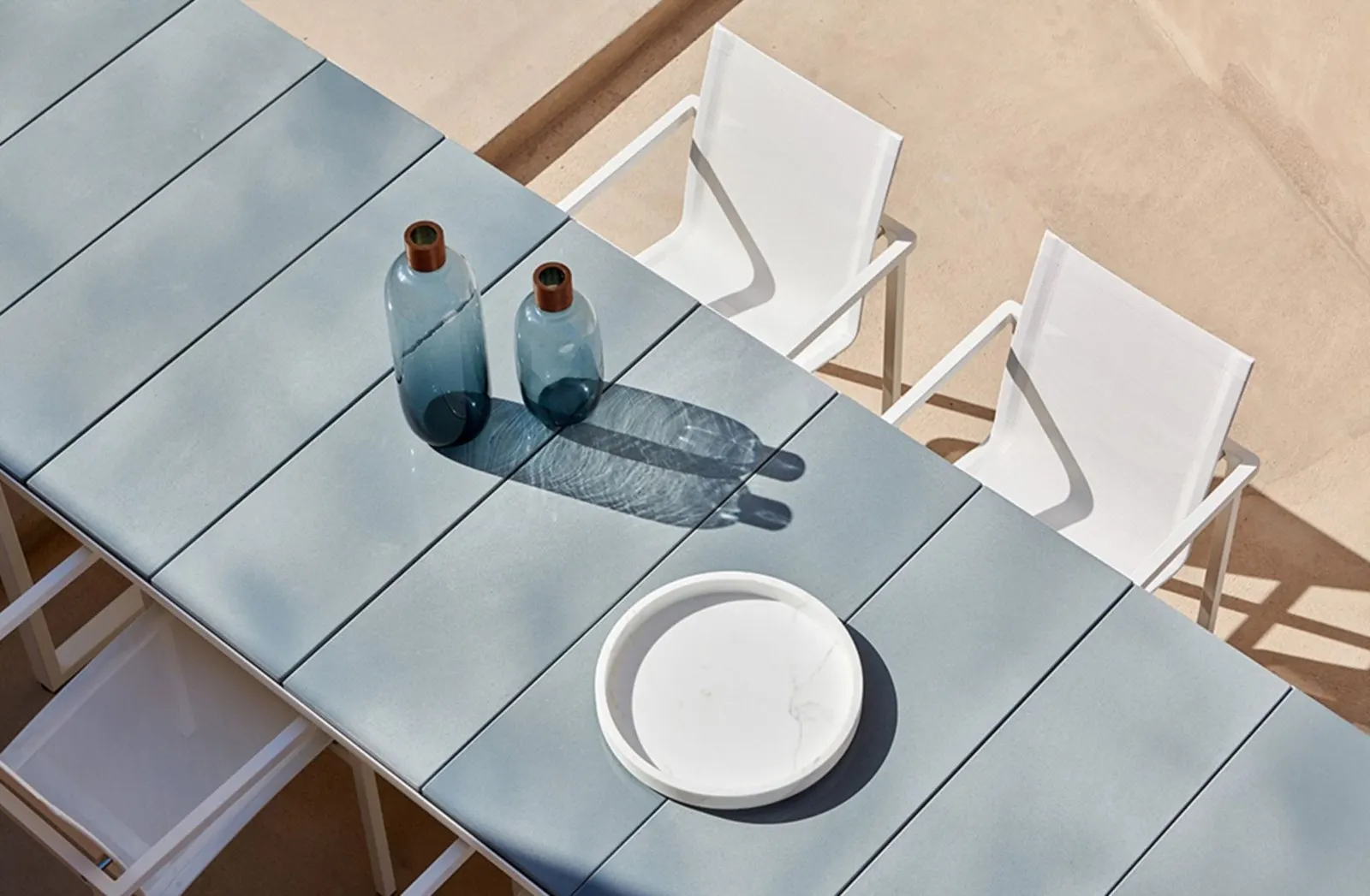 Outdoor dining table in glazed lava stone